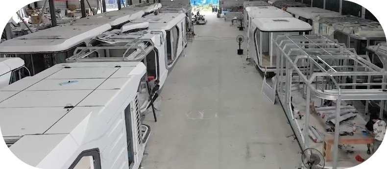 Clean and modern factory interior with steel frames being assembled.